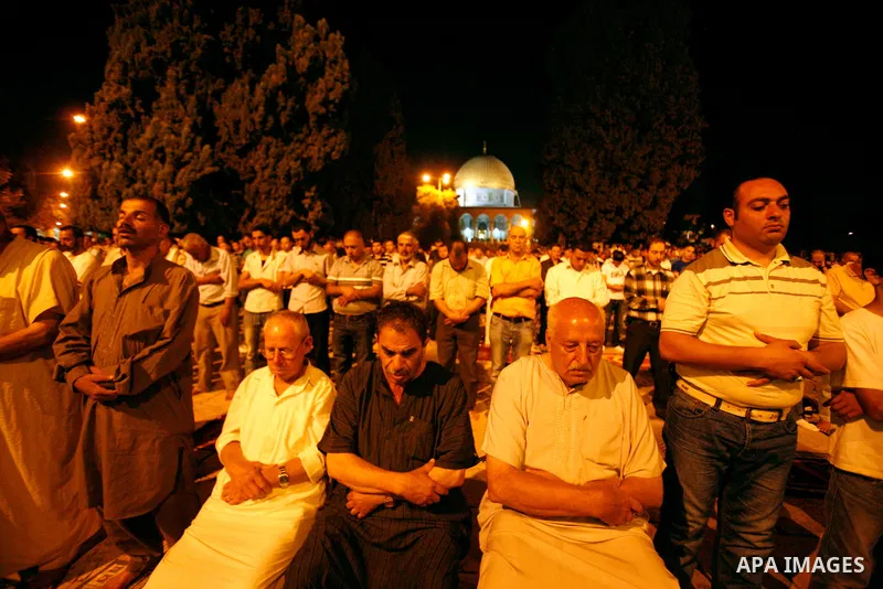 Palestinian worshippers attend night prayer at al-Aqsa Mosque in Jerusalem's Old City on the second day of the holy month of Ramadan, on 21 July 2012. Muslims around the world abstain from eating, drinking and conducting...