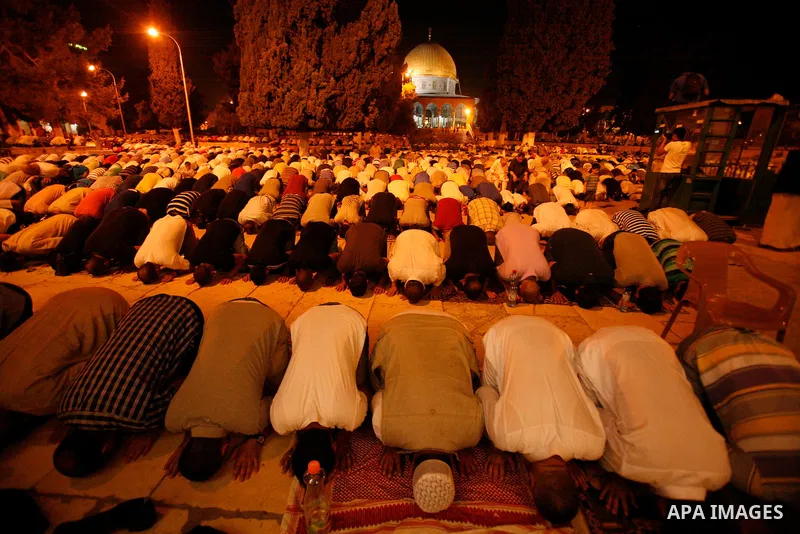 Palestinian worshippers attend night prayer at al-Aqsa Mosque in Jerusalem's Old City on the second day of the holy month of Ramadan, on 21 July 2012. Muslims around the world abstain from eating, drinking and conducting...