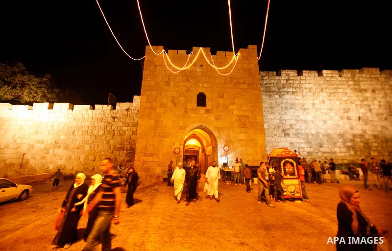 Palestinians walk near al-Aqsa Mosque in Jerusalem's Old City following the night prayer on the second day of the holy month of Ramadan, on 21 July 2012. Muslims around the world abstain from eating, drinking and conduct...