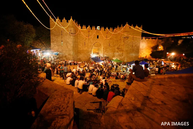 Palestinians walk near al-Aqsa Mosque in Jerusalem's Old City following the night prayer on the second day of the holy month of Ramadan, on 21 July 2012. Muslims around the world abstain from eating, drinking and conduct...