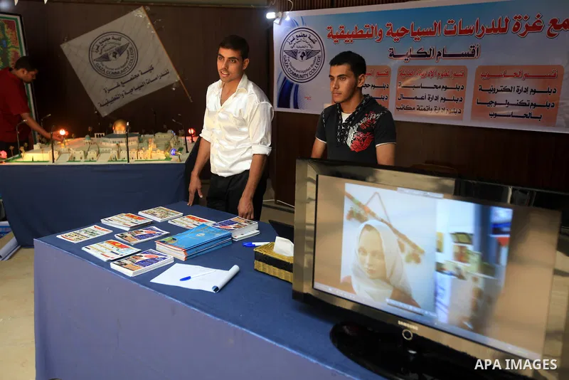Palestinian students participate in the exhibition for Palestine colleges in the Rashad Shawa Center in Gaza City, on July 22, 2012.. Photo by Majdi Fathi