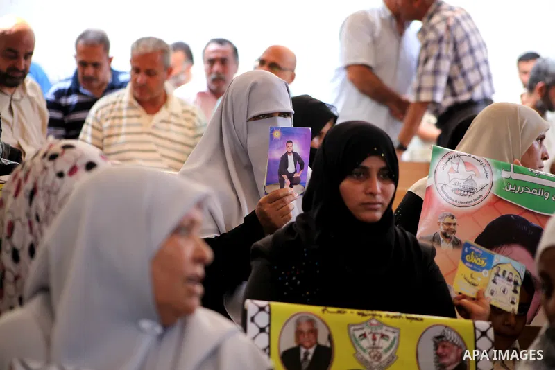 Palestinian relatives prisoners attend a protest calling for the release of their sons held in Israeli jails in front of the headquarters Red Cross in Gaza City, Gaza Strip, on July.23, 2012. Photo by Ashraf Amra