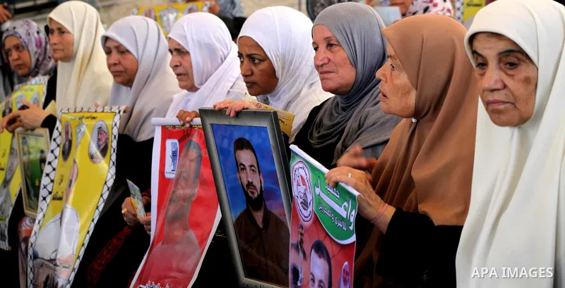 Palestinian relatives prisoners attend a protest calling for the release of their sons held in Israeli jails in front of the headquarters Red Cross in Gaza City, Gaza Strip, on July.23, 2012. Photo by Ashraf Amra
