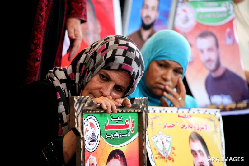 Palestinian relatives prisoners attend a protest calling for the release of their sons held in Israeli jails in front of the headquarters Red Cross in Gaza City, Gaza Strip, on July.23, 2012. Photo by Ashraf Amra