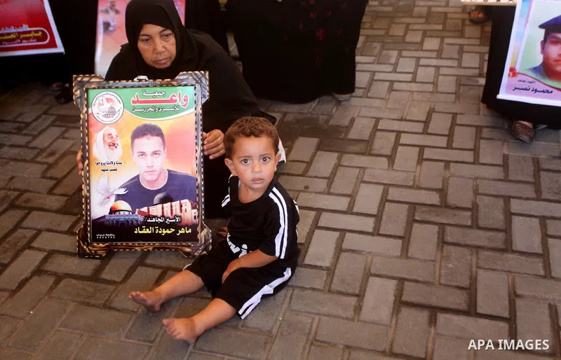 Palestinian relatives prisoners attend a protest calling for the release of their sons held in Israeli jails in front of the headquarters Red Cross in Gaza City, Gaza Strip, on July.23, 2012. Photo by Ashraf Amra