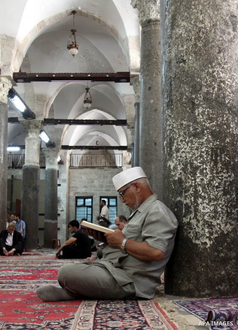 Palestinians read the holy Qur'an at the mosque in West Bank City of Nablus, on 23 July 2012. Muslims around the world refrain from eating, drinking and sexual intercourse from dawn till dusk during Ramadan, the holiest...