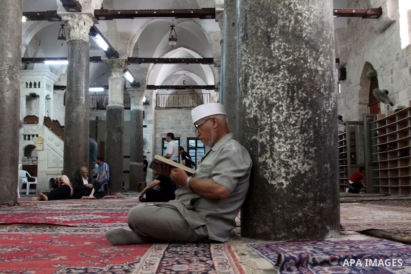 Palestinians read the holy Qur'an at the mosque in West Bank City of Nablus, on 23 July 2012. Muslims around the world refrain from eating, drinking and sexual intercourse from dawn till dusk during Ramadan, the holiest...