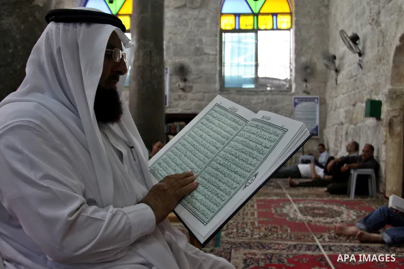 Palestinians read the holy Qur'an at the mosque in West Bank City of Nablus, on 23 July 2012. Muslims around the world refrain from eating, drinking and sexual intercourse from dawn till dusk during Ramadan, the holiest...