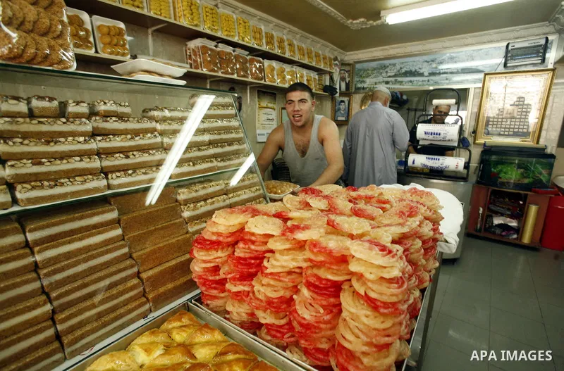 A Palestinian vendor sells traditional sweets consumed during Ramadan at the market of Jerusalem's old city, on July 23, 2012. Muslims around the world abstain from eating, drinking and conducting sexual relations from d...