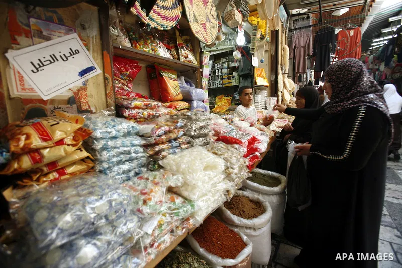 A Palestinian woman buy candy consumed during Ramadan at the market of Jerusalem's old city, on July 23, 2012. Muslims around the world abstain from eating, drinking and conducting sexual relations from dawn till dusk du...