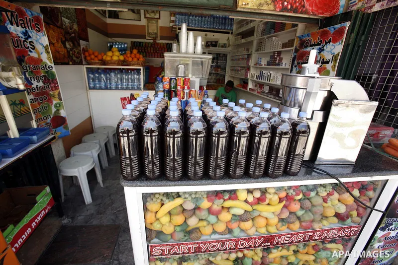 A Palestinian vendor sells juices during Ramadan at the market of Jerusalem's old city, on July 23, 2012. Muslims around the world abstain from eating, drinking and conducting sexual relations from dawn till dusk during...