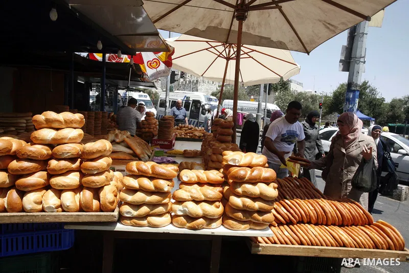 Palestinian vendors sell bread during Ramadan at the market of Jerusalem's old city, on July 23, 2012. Muslims around the world abstain from eating, drinking and conducting sexual relations from dawn till dusk during Ram...