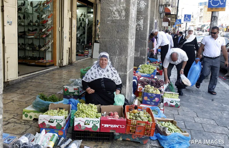 A Palestinian woman sells fruits during Ramadan in Jerusalem's old city, on July 23, 2012. Muslims around the world abstain from eating, drinking and conducting sexual relations from dawn till dusk during Ramadan, the ho...