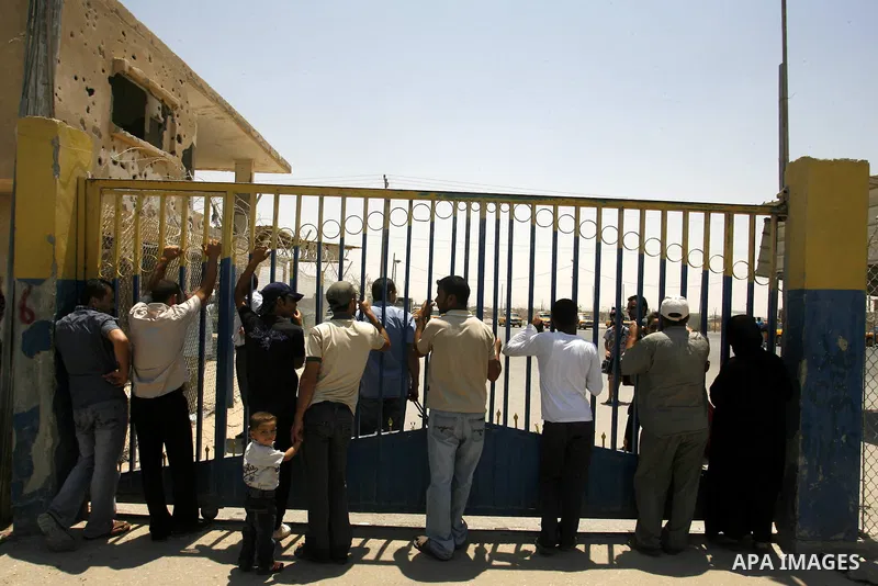 Palestinians wait the buses to cross to Egypt through the Rafah border crossing between the Gaza Strip and Egypt in Gaza city, on 24 July 2012. Egyptian Ambassador of Arab Republic , of the Palestinian Authority, Yasser...