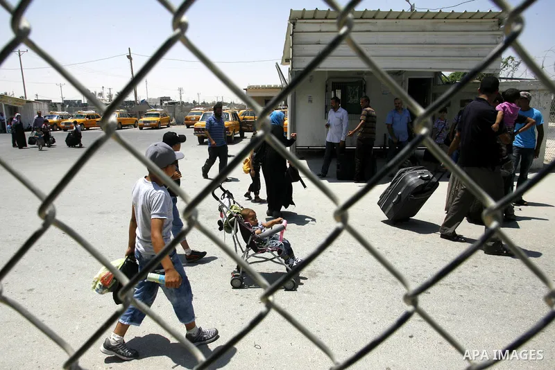 Palestinians wait the buses to cross to Egypt through the Rafah border crossing between the Gaza Strip and Egypt in Gaza city, on 24 July 2012. Egyptian Ambassador of Arab Republic , of the Palestinian Authority, Yasser...