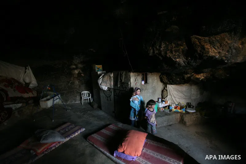 Palestinian children who live in caves near the Palestinian village of Jimba , south of Yatta, near the West Bank town of Hebron, rest on a mattress outside their home on July 25, 2012. The Israeli Defence Minister, Ehud...