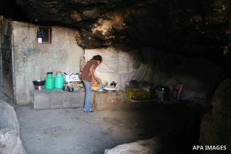 Palestinian children who live in caves near the Palestinian village of Jimba , south of Yatta, near the West Bank town of Hebron, rest on a mattress outside their home on July 25, 2012. The Israeli Defence Minister, Ehud...