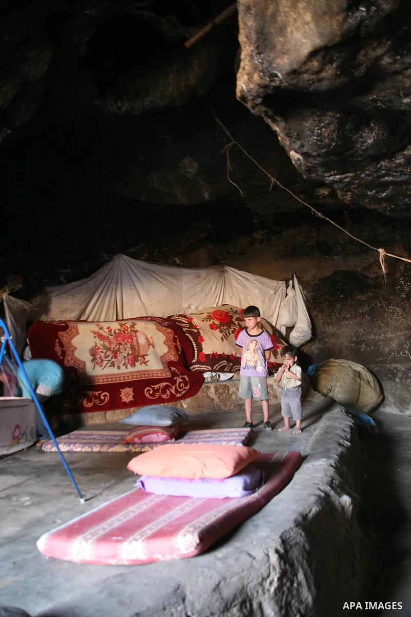 Palestinian children who live in caves near the Palestinian village of Jimba , south of Yatta, near the West Bank town of Hebron, rest on a mattress outside their home on July 25, 2012. The Israeli Defence Minister, Ehud...