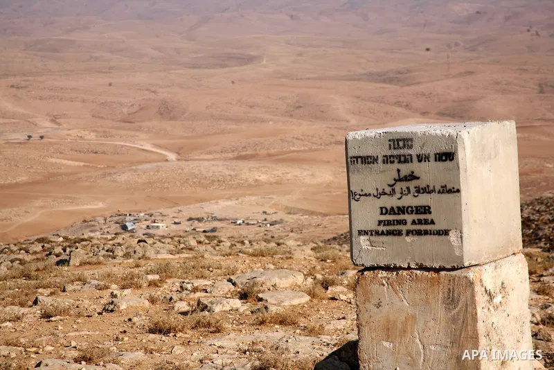 A sign installed by the Israeli army warning people of military activity in the area, is seen near the Palestinian village of Jimba, south of Yatta, near the West Bank town of Hebron, on July 25, 2012. The Israeli Defenc...