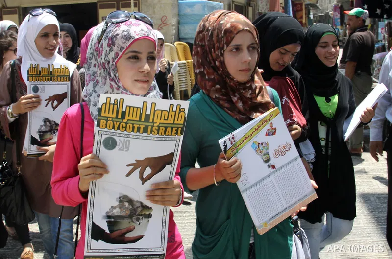 Palestinian youths demonstrate for a boycott of Israeli goods and support national products during a protest in the West Bank city of Nablus,on July 26,2012. Photo by Nedal Shtieh . Photo by Nedal Eshtayah