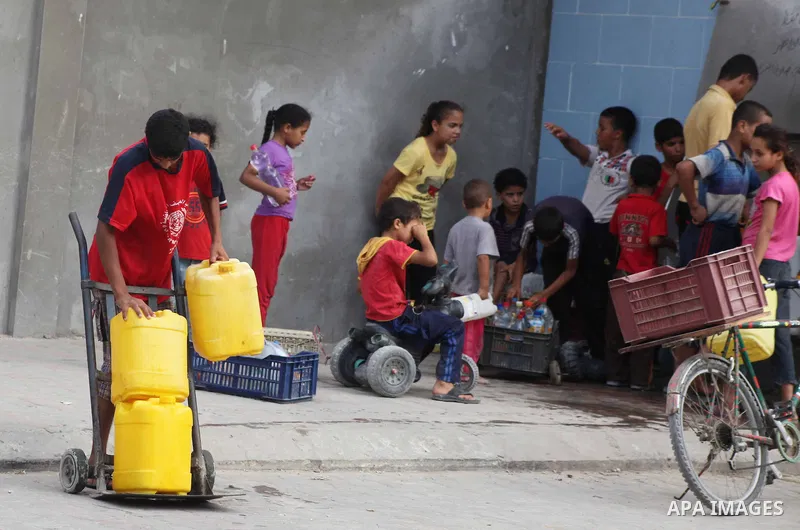 Palestinians fill their bottles a potable water at a water purification station, in Deir al-Balah central Gaza Strip, on July 26. 2012. Palestinians suffer from the severe lack of potable water during the holy fasting mo...