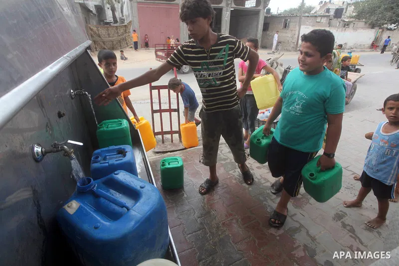 Palestinians fill their bottles a potable water at a water purification station, in Deir al-Balah central Gaza Strip, on July 26. 2012. Palestinians suffer from the severe lack of potable water during the holy fasting mo...