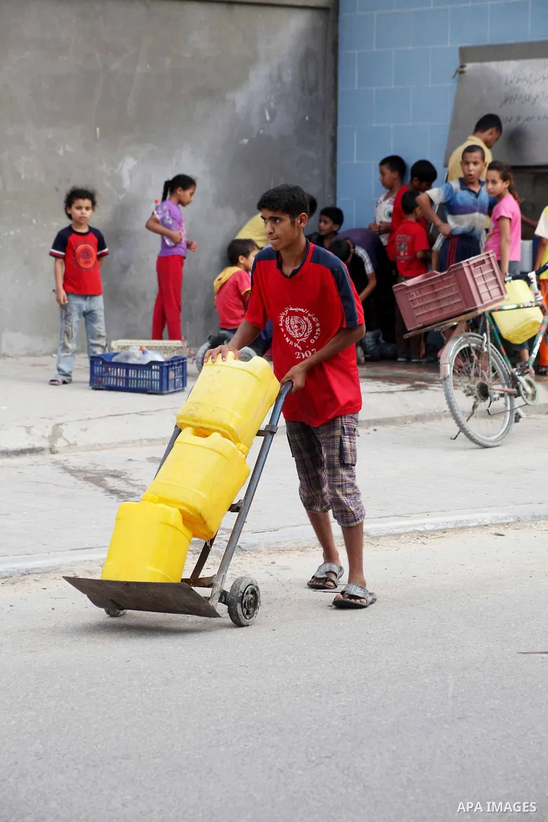 Palestinians fill their bottles a potable water at a water purification station, in Deir al-Balah central Gaza Strip, on July 26. 2012. Palestinians suffer from the severe lack of potable water during the holy fasting mo...