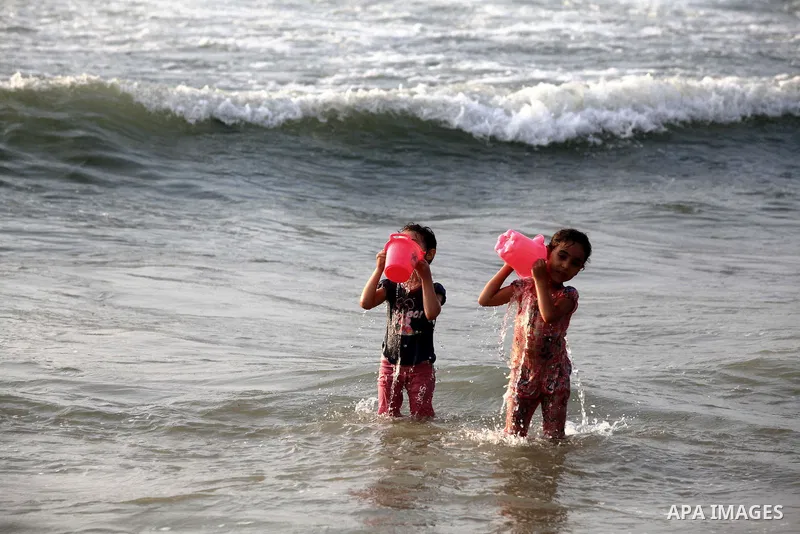 Palestinian children enjoy swimming at Gaza beach during the fasting holy month of Ramadan, in Gaza city on 26 July 2012. Photo by Majdi Fathi