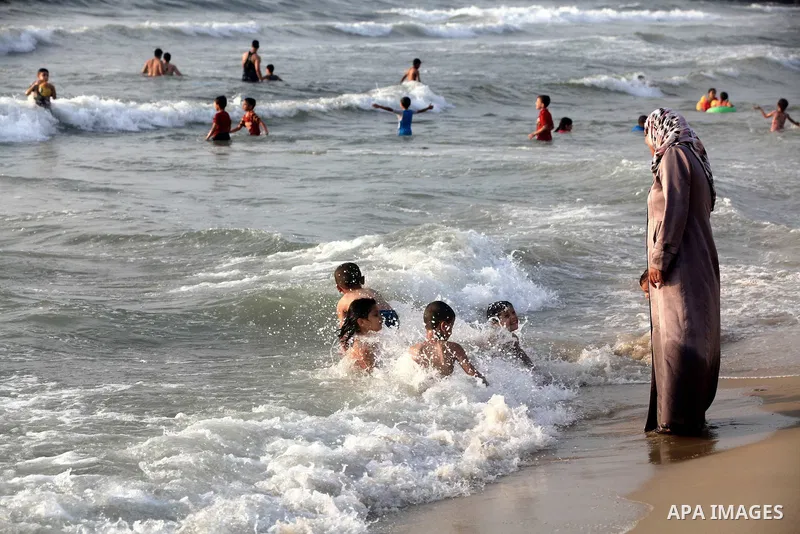 Palestinian children enjoy swimming at Gaza beach during the fasting holy month of Ramadan, in Gaza city on 26 July 2012. Photo by Majdi Fathi