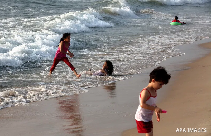 Palestinian children enjoy swimming at Gaza beach during the fasting holy month of Ramadan, in Gaza city on 26 July 2012. Photo by Majdi Fathi