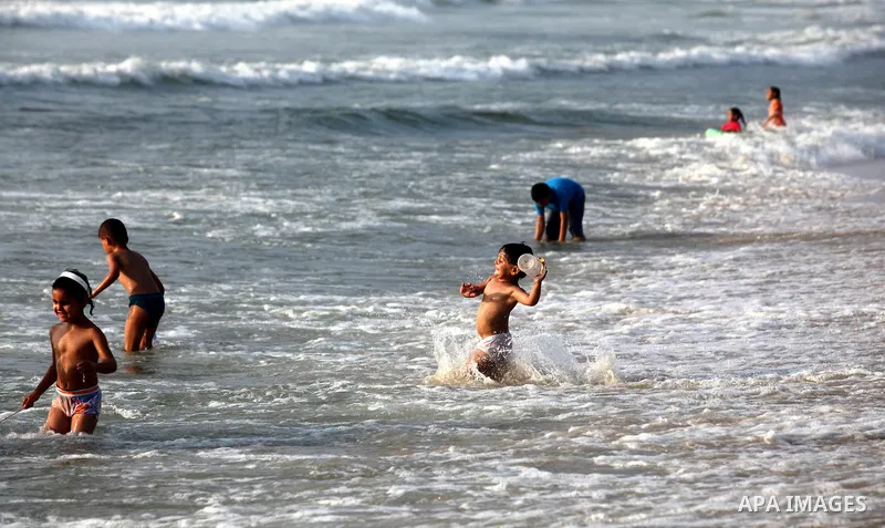 Palestinian children enjoy swimming at Gaza beach during the fasting holy month of Ramadan, in Gaza city on 26 July 2012. Photo by Majdi Fathi