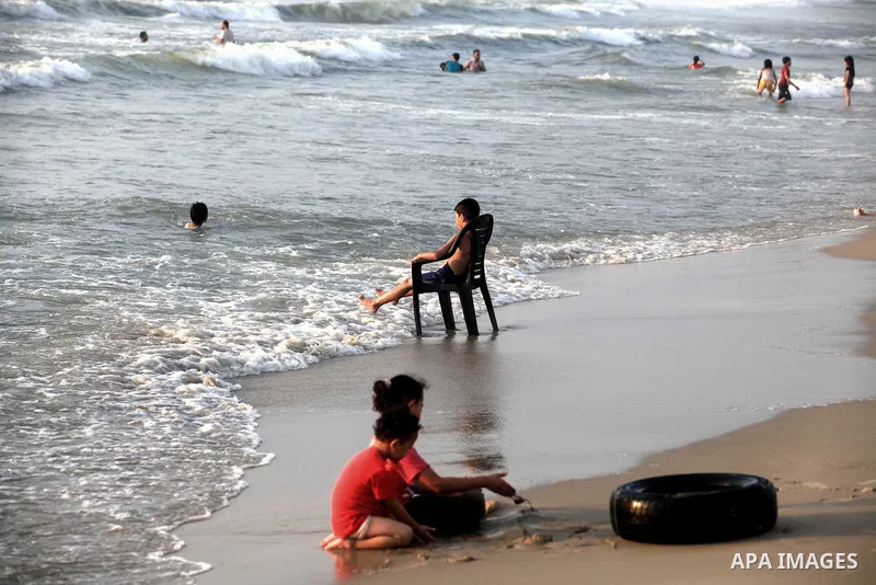Palestinian children enjoy swimming at Gaza beach during the fasting holy month of Ramadan, in Gaza city on 26 July 2012. Photo by Majdi Fathi