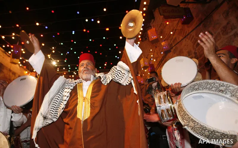 Palestinian musicians perform in Jerusalem's Old City during celebrations to mark the breaking of the fast on the seventh day of the holy month of Ramadan, on July 26, 2012. Photo by Mahfouz Abu Turk