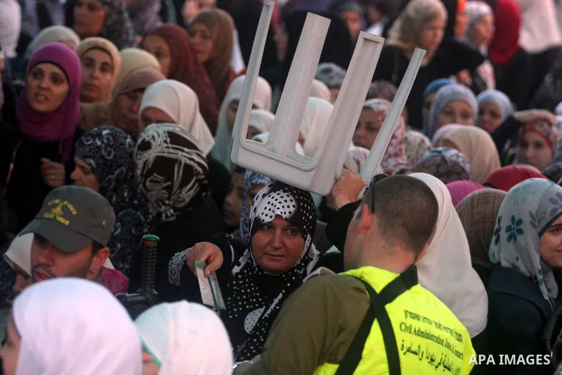 Israeli border policemen check the ID cards of Palestinian women at Qalandiya checkpoint outside the West Bank city of Ramallah July 27, 2012, as they make their way to Jerusalem on the second Friday of the holy month of...