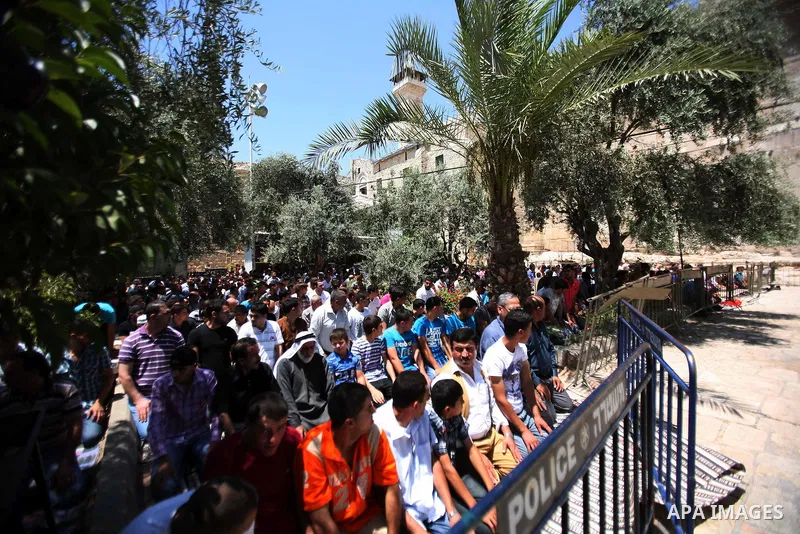 Palestinians perform the second Friday prayers of the Muslim fasting month of Ramadan outside the Ibrahimi Mosque or the Tomb of the Patriarchs in the West Bank city of Hebron on July 27, 2012. Photo by Mamoun Wazwaz
