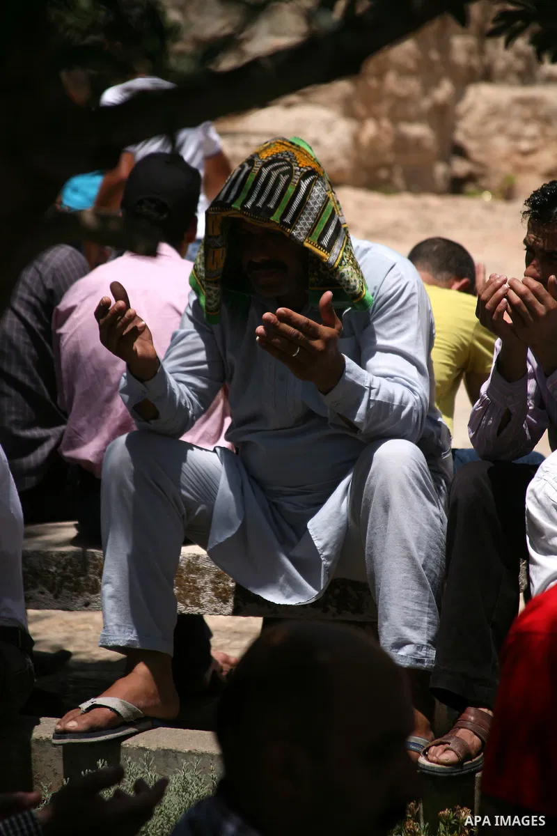 Palestinians perform the second Friday prayers of the Muslim fasting month of Ramadan outside the Ibrahimi Mosque or the Tomb of the Patriarchs in the West Bank city of Hebron on July 27, 2012. Photo by Mamoun Wazwaz