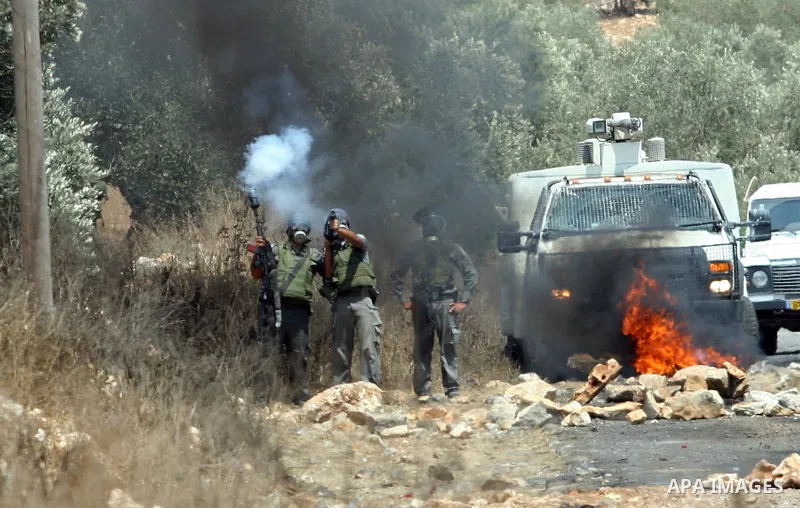 Israeli soldiers fire tear gas towards Palestinian protesters during clashes following a demonstrator against the expropriation of Palestinian land by Israel in the village of Kafr Qaddum, near the West Bank city of Nabl...