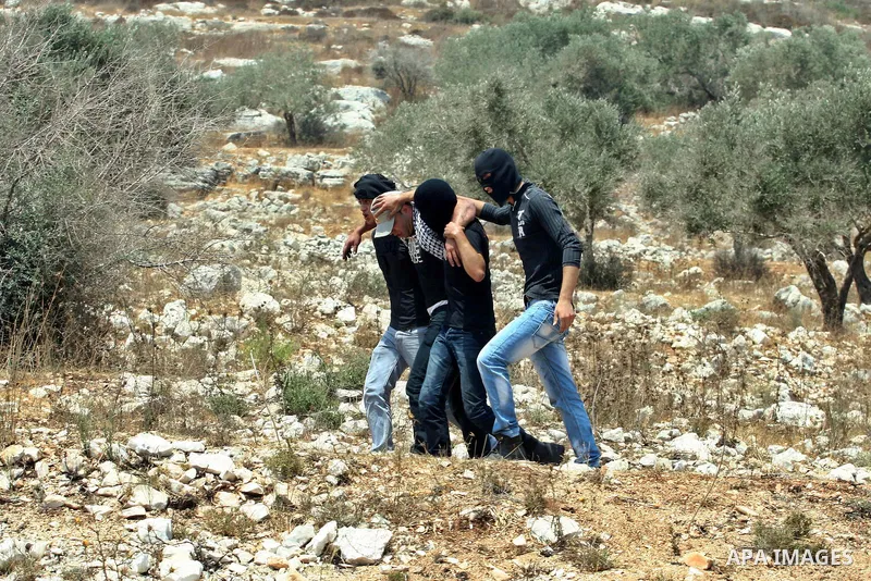 Palestinians help an injured protester during clashes with Israeli soldiers following a demonstrator against the expropriation of Palestinian land by Israel in the village of Kafr Qaddum, near the West Bank city of Nablu...