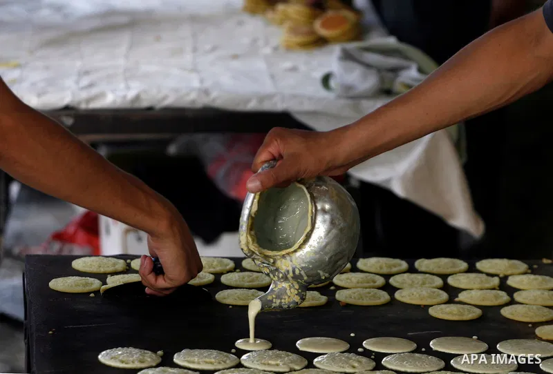 A Palestinian man prepares traditional pancake known as ''Qatayef'' consumed during the fasting month of Ramadan in Rafah refugee camp southern Gaza strip, on July 27, 2012. Muslims around the world abstain from eating,...