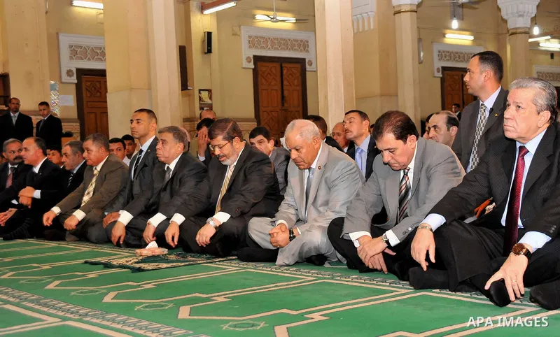 Egyptian President Mohamed Morsi performing Friday noon prayers at a mosque in the district of Fayoum, south west of Cairo, during the Muslim holy fasting month of Ramadan, on July 27, 2012. Photo by Egyptian Presidency