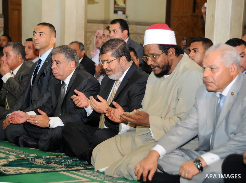 Egyptian President Mohamed Morsi performing Friday noon prayers at a mosque in the district of Fayoum, south west of Cairo, during the Muslim holy fasting month of Ramadan, on July 27, 2012. Photo by Egyptian Presidency