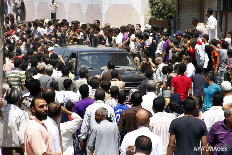 Egypt's President Mohamed Mursi (not pictured) gather outside a mosque where Mursi will be taking part in Friday prayers during the Islamic holy month of Ramadan in Fayoum, about 100 km (60 miles) southeast of Cairo, Jul...