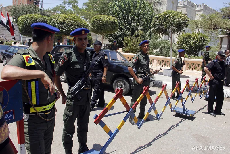 Egyptian policemen stand guard outside a mosque where Mursi will be taking part in Friday prayers during the Islamic holy month of Ramadan in Fayoum, about 100 km (60 miles) southeast of Cairo, July 27, 2012. Photo by Am...