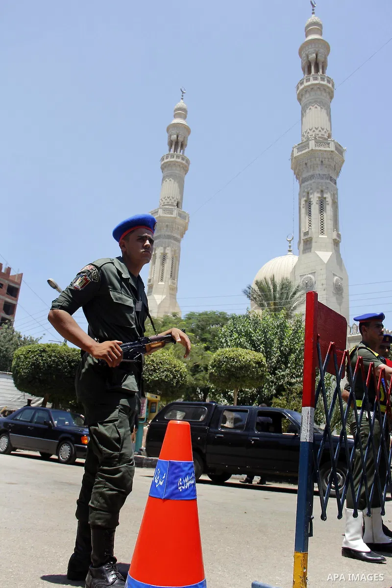 Egyptian policemen stand guard outside a mosque where Mursi will be taking part in Friday prayers during the Islamic holy month of Ramadan in Fayoum, about 100 km (60 miles) southeast of Cairo, July 27, 2012. Photo by Am...