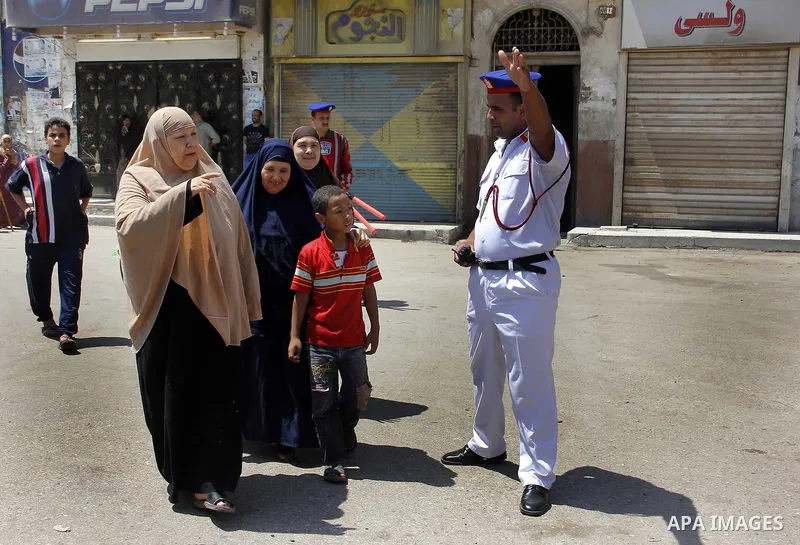 Egypt's President Mohamed Mursi (not pictured) gather outside a mosque where Mursi will be taking part in Friday prayers during the Islamic holy month of Ramadan in Fayoum, about 100 km (60 miles) southeast of Cairo, Jul...