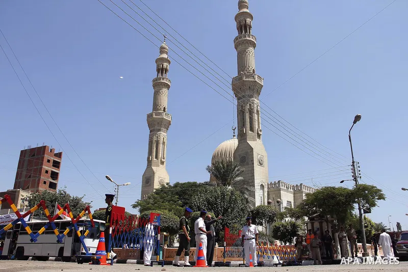 Egypt's President Mohamed Mursi (not pictured) gather outside a mosque where Mursi will be taking part in Friday prayers during the Islamic holy month of Ramadan in Fayoum, about 100 km (60 miles) southeast of Cairo, Jul...