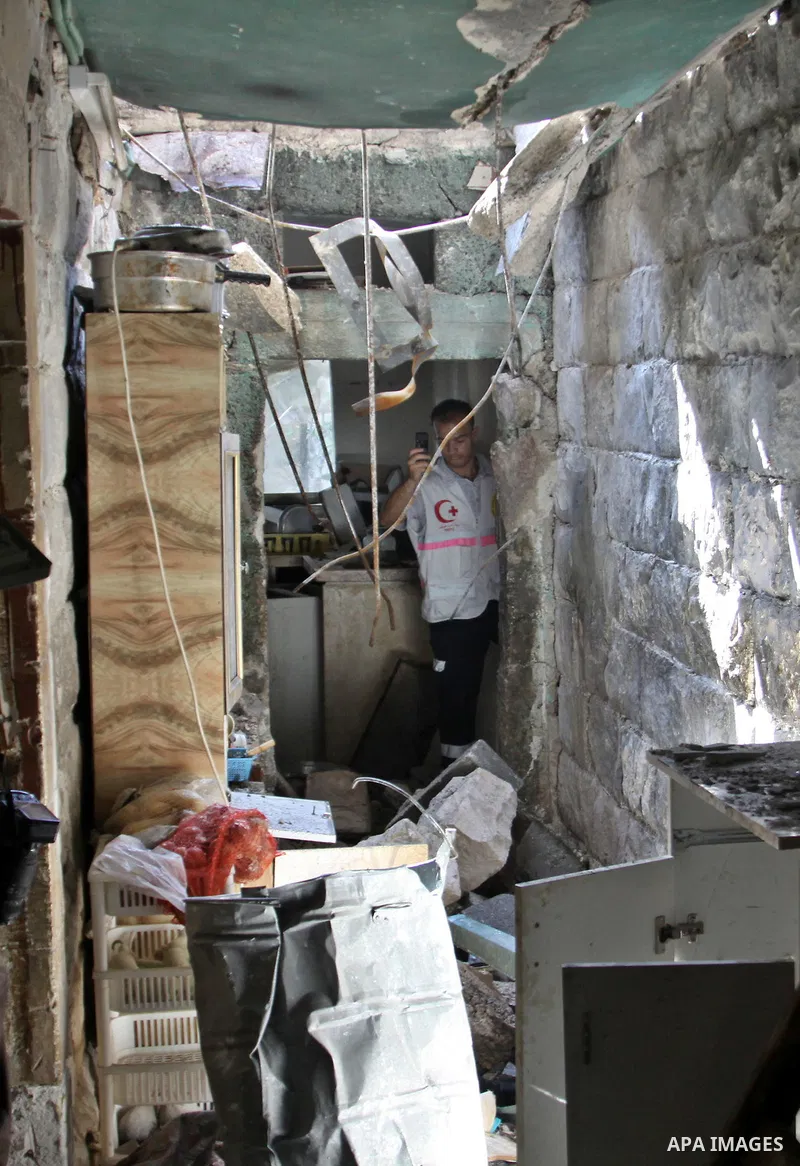 A Palestinian man inspects damage in house for member Islamic Jihad, Abdullah Al Kharouf in the West Bank city of Nablus on 28 July 2012. Photo by Nedal Eshtayah