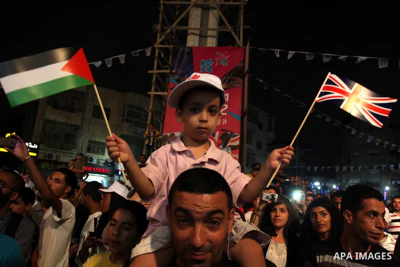 Palestinians celebrate of the opening Olympics Games in London, on July 27, 2012, in the West Bank city of Ramallah. Photo by Issam Rimawi