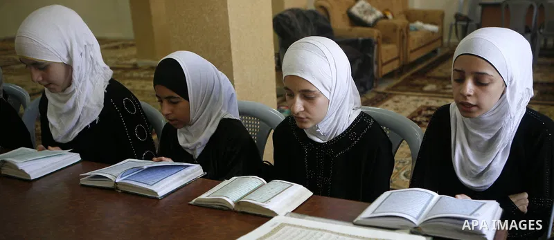 Palestinian girls read the holy Qur'an at mosque in the West bank city of Nablus, on 29 July 2012. Muslims around the world refrain from eating, drinking and sexual intercourse from dawn till dusk during Ramadan, the hol...