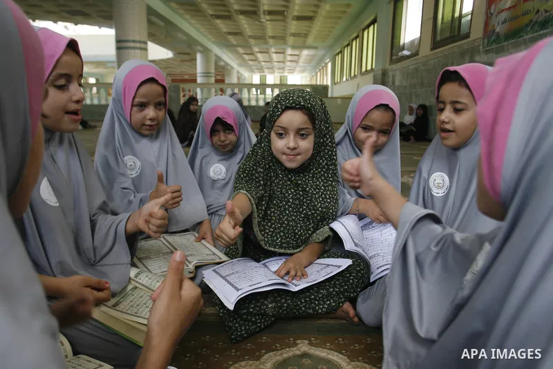 Palestinian girls read the holy Qur'an at mosque in Rafah in southern Gaza strip, on 29 July 2012. Muslims around the world refrain from eating, drinking and sexual intercourse from dawn till dusk during Ramadan, the hol...